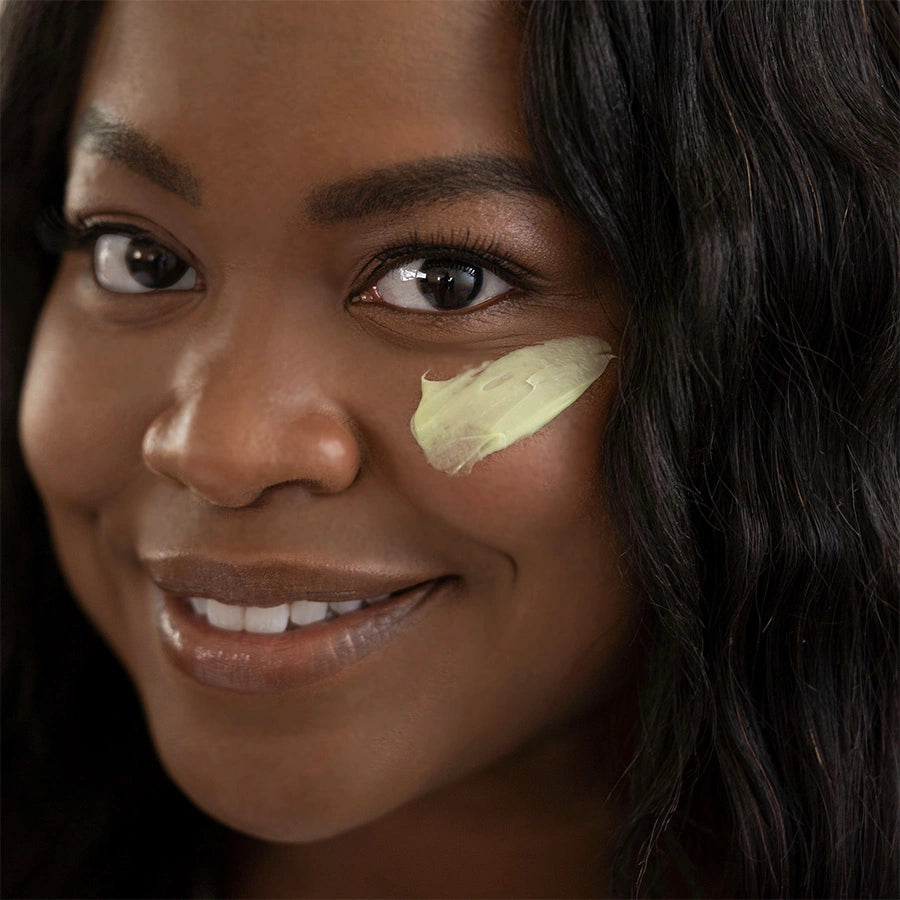 Woman applying VegOut Skin Perfect Moisturizer to face — natural plant-based skincare for hydrated, radiant skin.