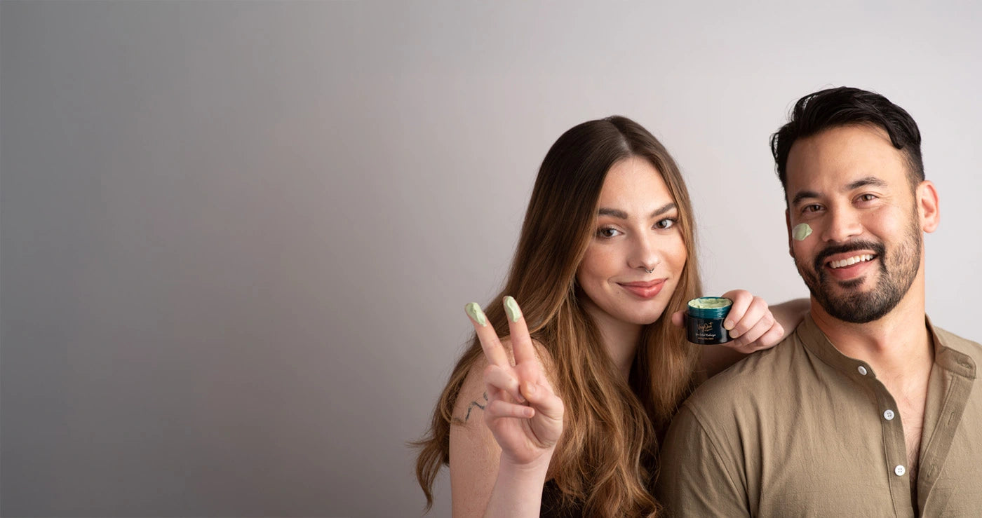 Smiling couple applying organic skincare cream – natural and vegan beauty routine.
