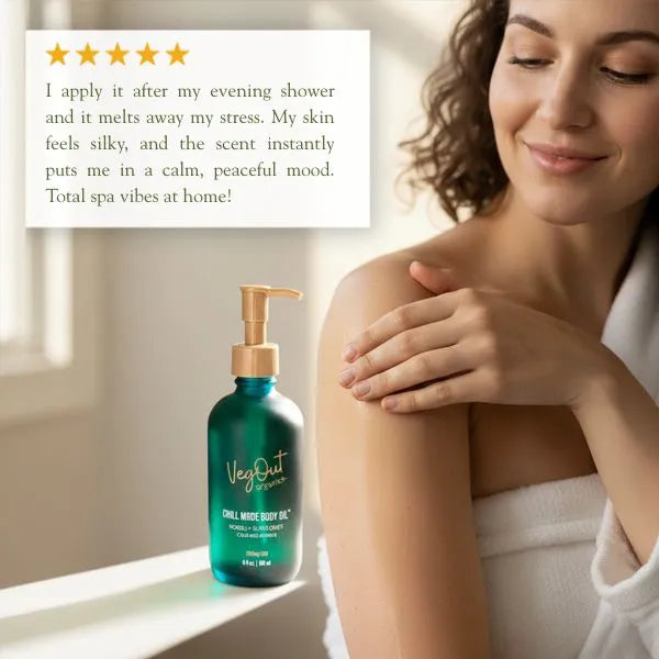 Woman smiling in a cozy white robe while applying Chill Mode Body Oil by VegOut Organics. A product review overlay highlights the calming and spa-like experience, emphasizing silky skin and relaxing scent. Five-star rating included.