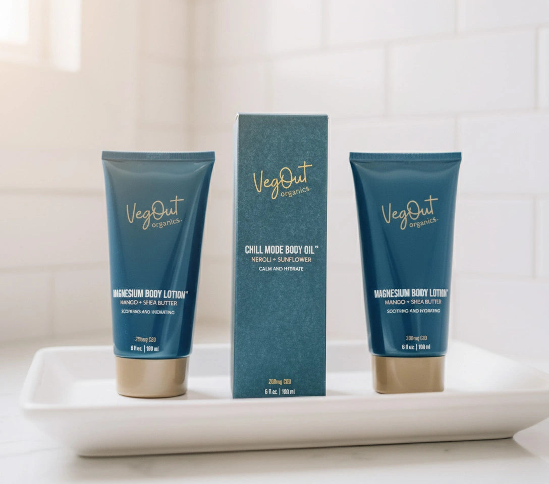 Two Magnesium Body Lotions and a boxed Chill Mode Body Oil from VegOut Organics, displayed on branded paper, showcasing a premium plant-based skincare set for deep hydration and relaxation.